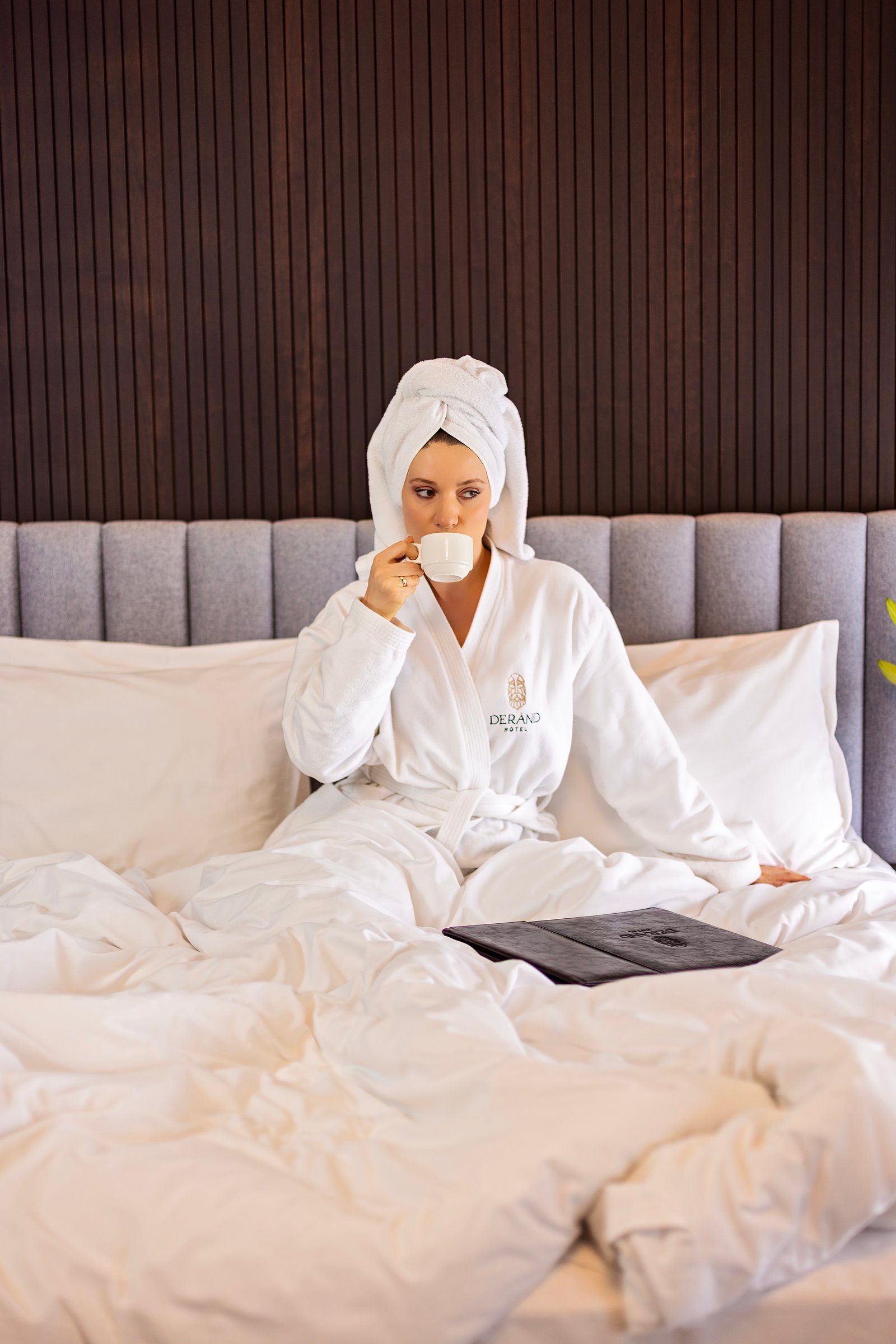 Junior Suite interior — bed, headboard, and lighting